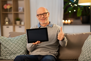 Image showing happy senior man with tablet computer at home