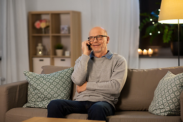 Image showing happy senior man calling on smartphone at home