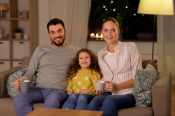 Image showing portrait of happy family sitting on sofa at home