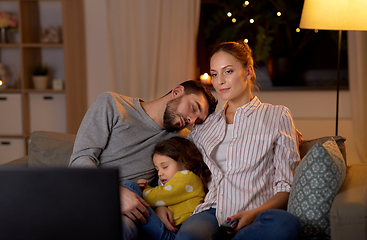 Image showing tired sleepy family watching tv at home at night