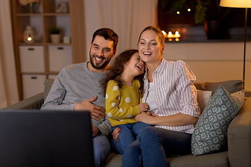 Image showing happy family watching tv at home at night