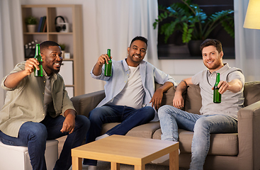 Image showing happy male friends drinking beer at home at night