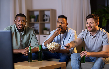 Image showing happy male friends with beer watching tv at home