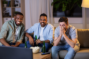 Image showing happy male friends with beer watching tv at home