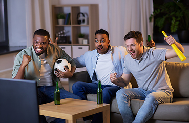 Image showing friends with ball and vuvuzela watching soccer