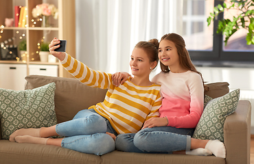 Image showing happy girls taking selfie with smartphone at home