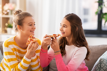 Image showing happy teenage girls eating pizza at home