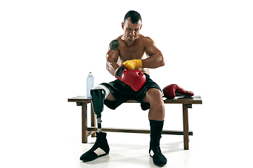 Image showing Full length portrait of muscular sportsman with prosthetic leg, copy space. Male boxer in red gloves.