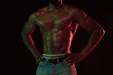 Image showing Young african-american basketball player against dark background