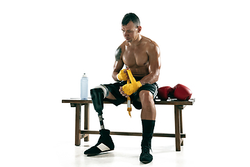 Image showing Full length portrait of muscular sportsman with prosthetic leg, copy space. Male boxer in red gloves.