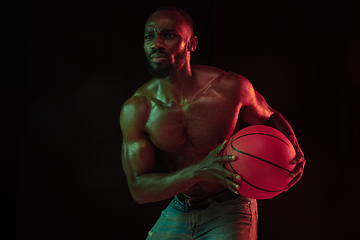 Image showing Young african-american basketball player against dark background