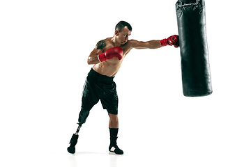 Image showing Full length portrait of muscular sportsman with prosthetic leg, copy space. Male boxer in red gloves.