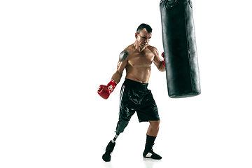 Image showing Full length portrait of muscular sportsman with prosthetic leg, copy space. Male boxer in red gloves.