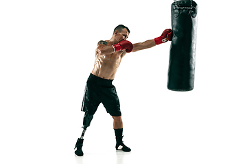 Image showing Full length portrait of muscular sportsman with prosthetic leg, copy space. Male boxer in red gloves.