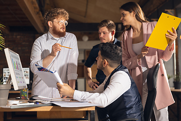 Image showing Colleagues working together in modern office using devices and gadgets during creative meeting