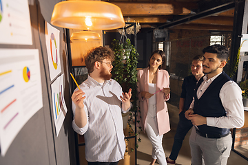 Image showing Colleagues working together in modern office using devices and gadgets during creative meeting