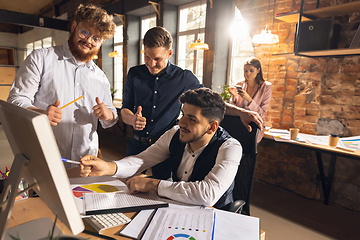 Image showing Colleagues working together in modern office using devices and gadgets during creative meeting