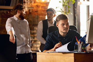 Image showing Colleagues working together in modern office using devices and gadgets during creative meeting