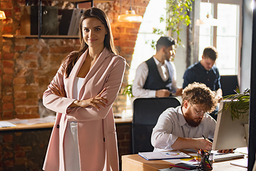 Image showing Colleagues working together in modern office using devices and gadgets during creative meeting