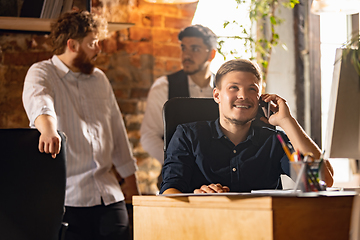 Image showing Colleagues working together in modern office using devices and gadgets during creative meeting