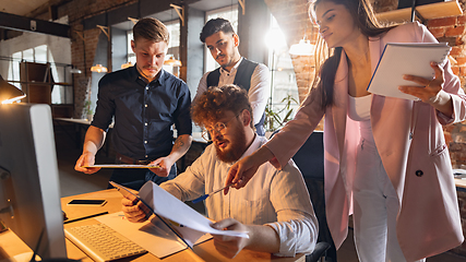 Image showing Colleagues working together in modern office using devices and gadgets during creative meeting