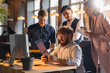 Image showing Colleagues working together in modern office using devices and gadgets during creative meeting