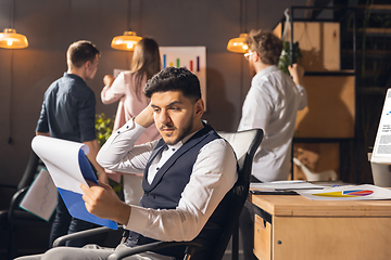 Image showing Colleagues working together in modern office using devices and gadgets during creative meeting