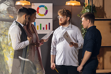 Image showing Colleagues working together in modern office using devices and gadgets during creative meeting