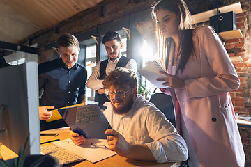 Image showing Colleagues working together in modern office using devices and gadgets during creative meeting