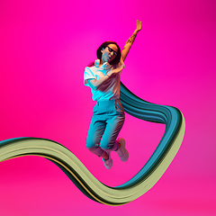 Image showing Stylish woman with long fluid flood on gradient background. Negative space to insert your text. Modern design. Contemporary colorful and conceptual bright art collage.