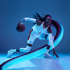 Image showing Beautiful basketball player with long fluid flood on gradient background. Negative space to insert your text. Modern design. Contemporary colorful and conceptual bright art collage.