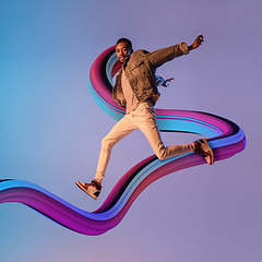 Image showing Stylish man with long fluid flood on gradient background. Negative space to insert your text. Modern design. Contemporary colorful and conceptual bright art collage.