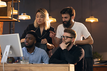 Image showing Colleagues working together in modern office using devices and gadgets during creative meeting