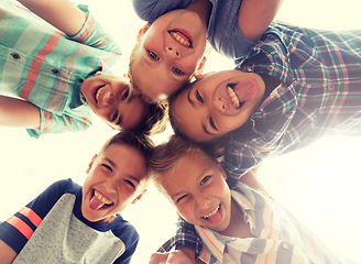 Image showing group of happy children showing tongue in circle