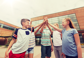 Image showing group of children making high five at school yard