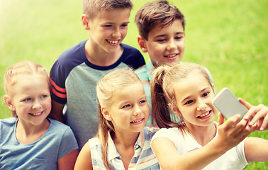 Image showing happy kids or friends taking selfie in summer park