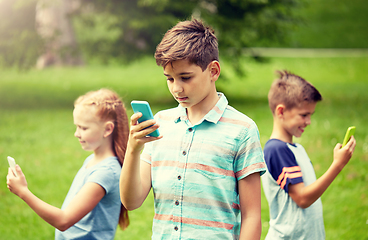 Image showing kids with smartphones playing game in summer park