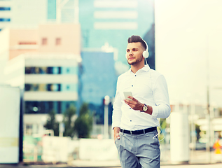 Image showing man with headphones and smartphone listening music