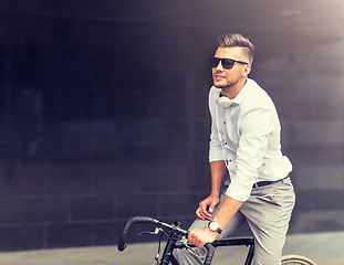 Image showing man with bicycle and headphones on city street