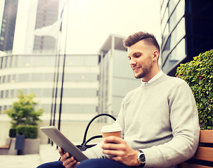 Image showing man with tablet pc and coffee on city street bench