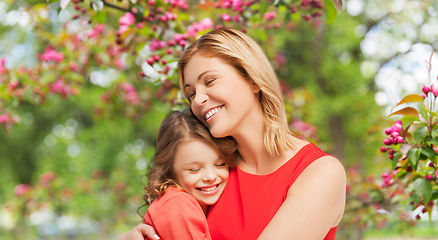 Image showing happy mother and daughter hugging over garden