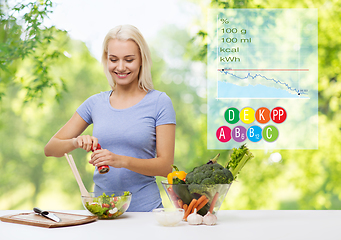 Image showing smiling woman cooking vegetable salad