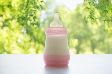 Image showing infant milk formula in baby bottle on table