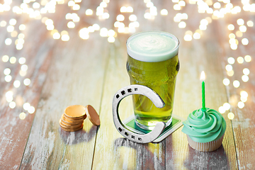 Image showing glass of beer, cupcake, horseshoe and gold coins