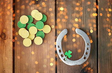 Image showing horseshoe with shamrock on wooden background