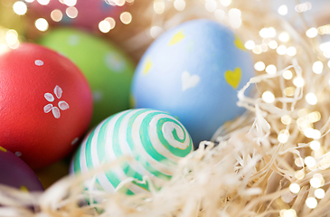 Image showing close up of colored easter eggs in straw