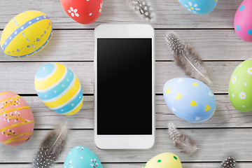 Image showing smartphone with easter eggs and feathers