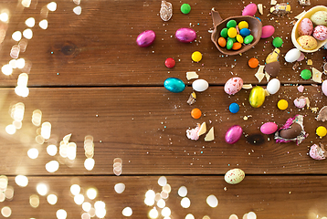 Image showing chocolate eggs and candy drops on wooden table