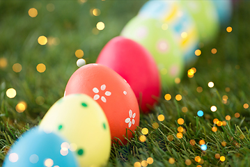 Image showing row of colored easter eggs on artificial grass