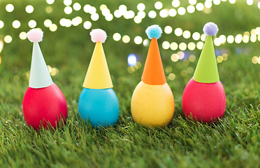 Image showing easter eggs in party hats on artificial grass